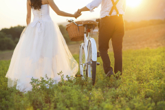 Bride and groom with a white wedding bike